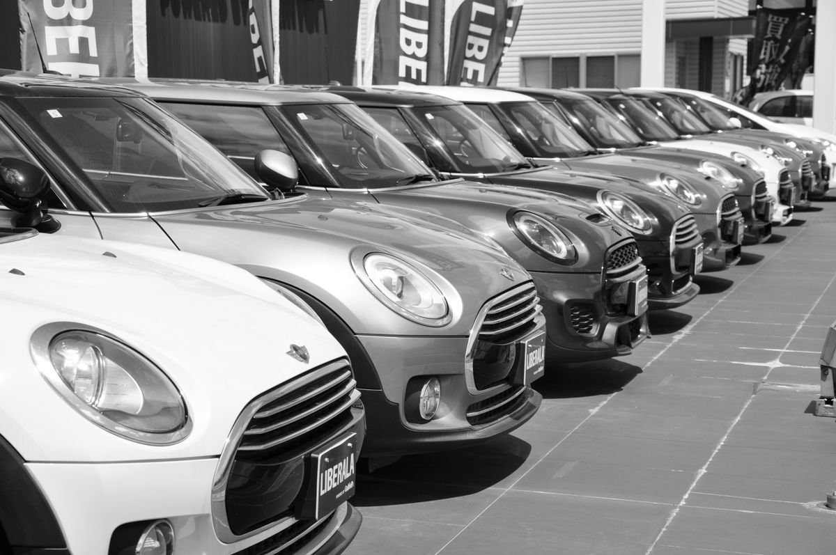 Row of vans parked at a dealership