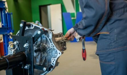 Mechanic repairing a van transmission in a workshop