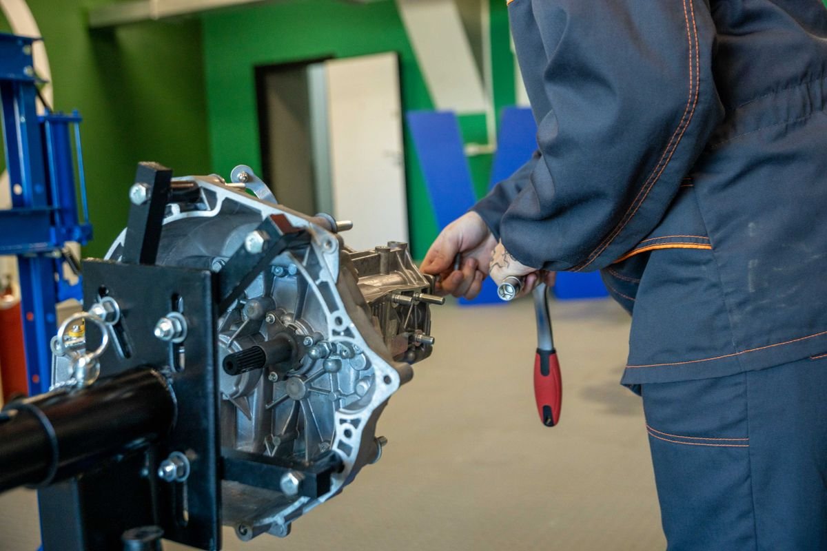 Mechanic repairing a van transmission in a workshop