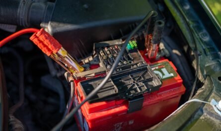 Car battery with red jumper cables connected