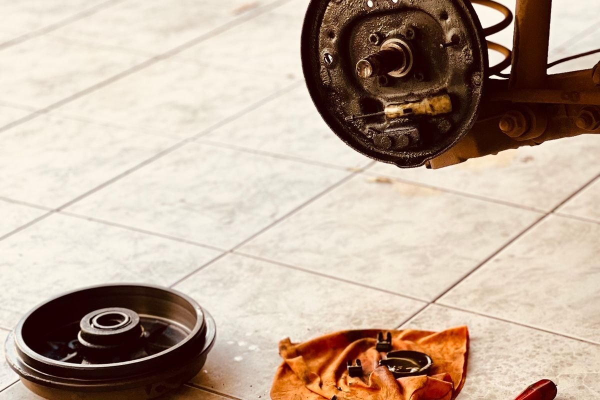 Dismantled brake rotor and tools in a garage