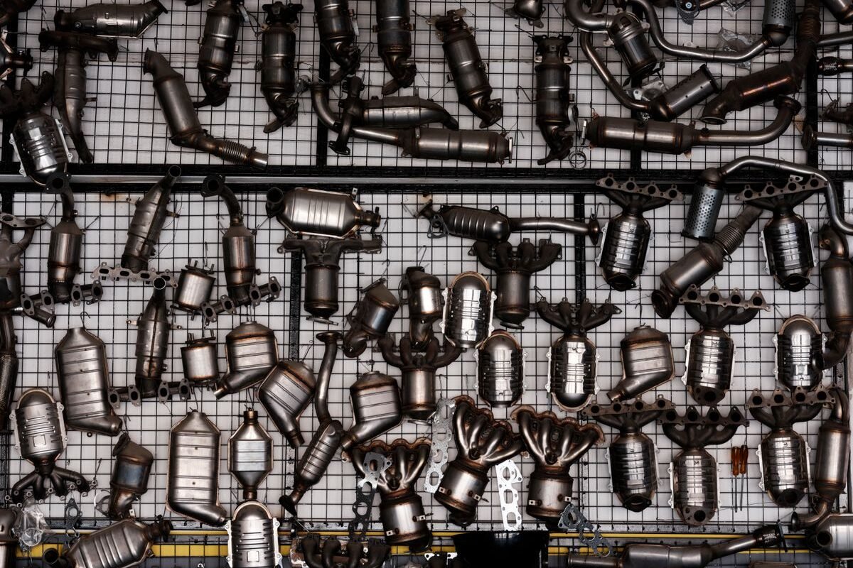 Automotive exhaust parts displayed in a garage