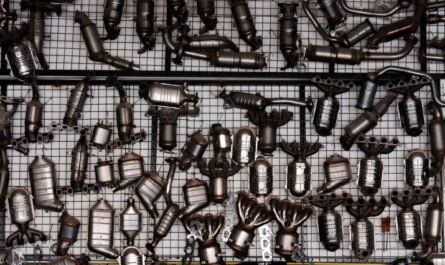 Automotive exhaust parts displayed in a garage