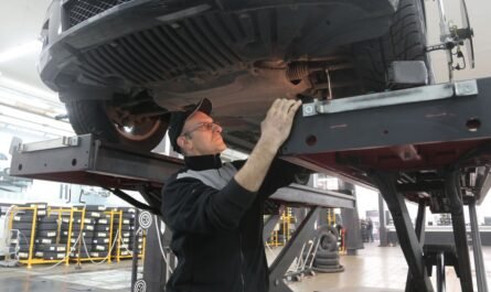 Mechanic inspecting a vehicle on a lift