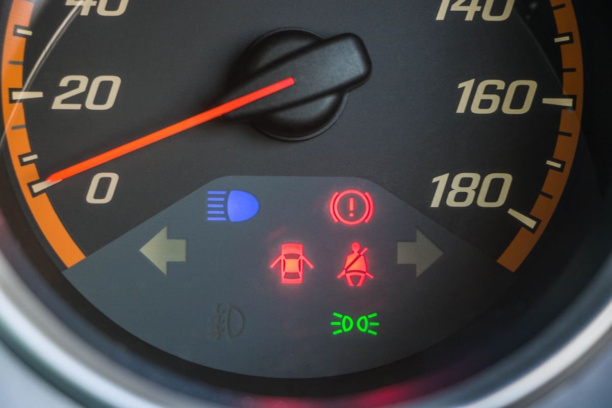Car speedometer with illuminated warning indicators