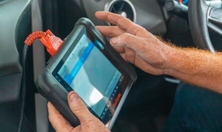 Mechanic using a diagnostic tablet inside a van