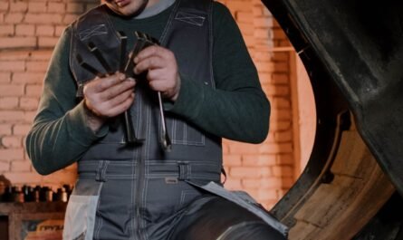 Mechanic tuning up diesel engine parts with precision tools