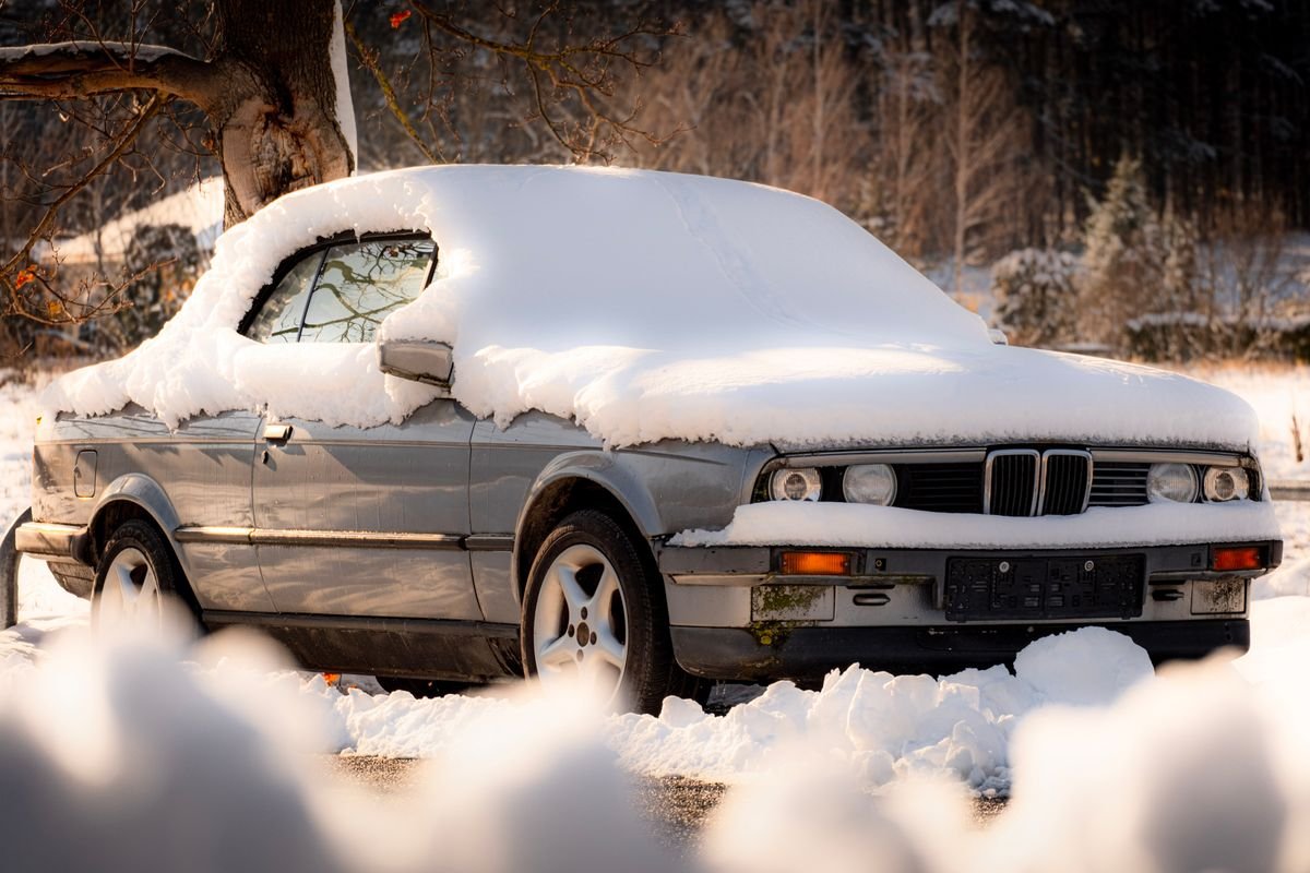 Vehicle covered in snow during cold winter weather