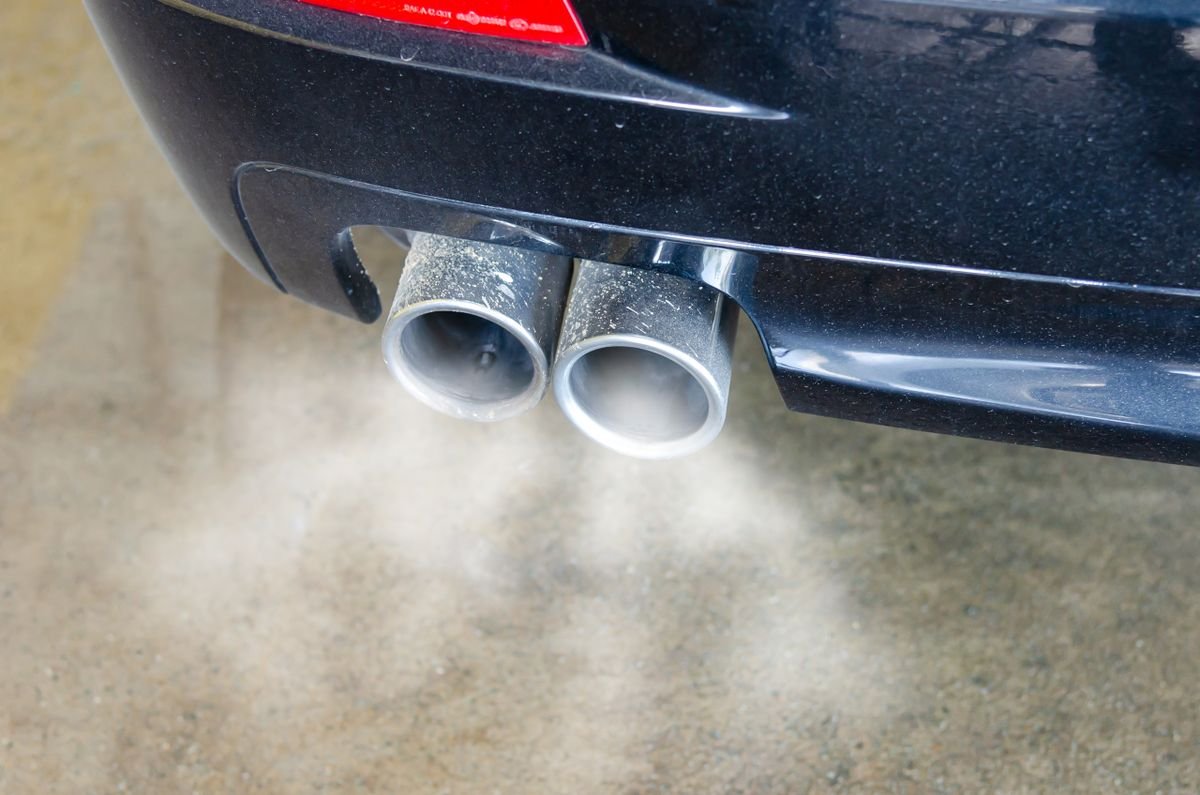 Close-up of exhaust pipes emitting visible smoke