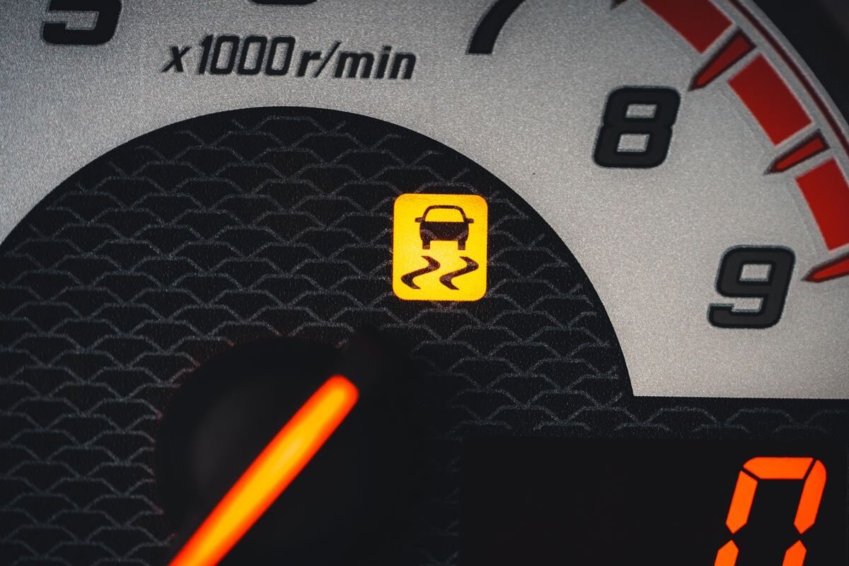 Car dashboard showing an illuminated warning light
