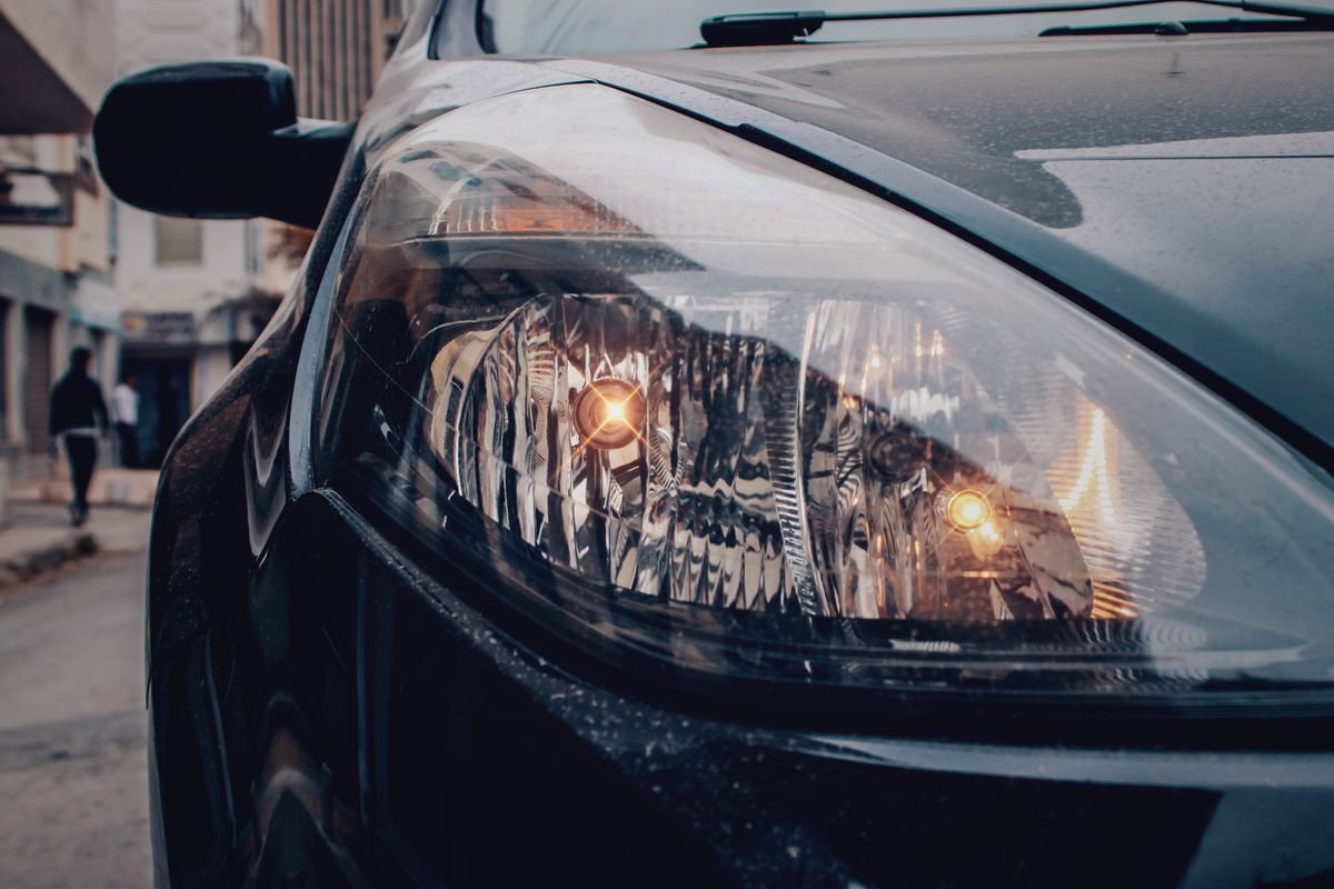 Close-up of a vehicle headlight on a street