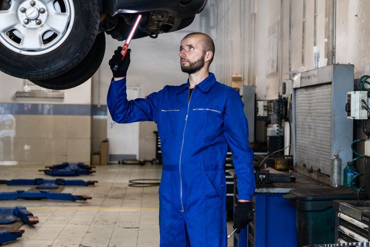 Mechanic inspecting a van engine during a service