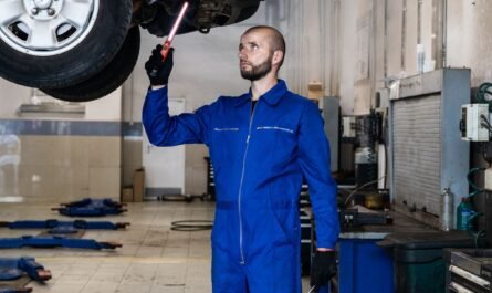 Mechanic inspecting a van engine during a service