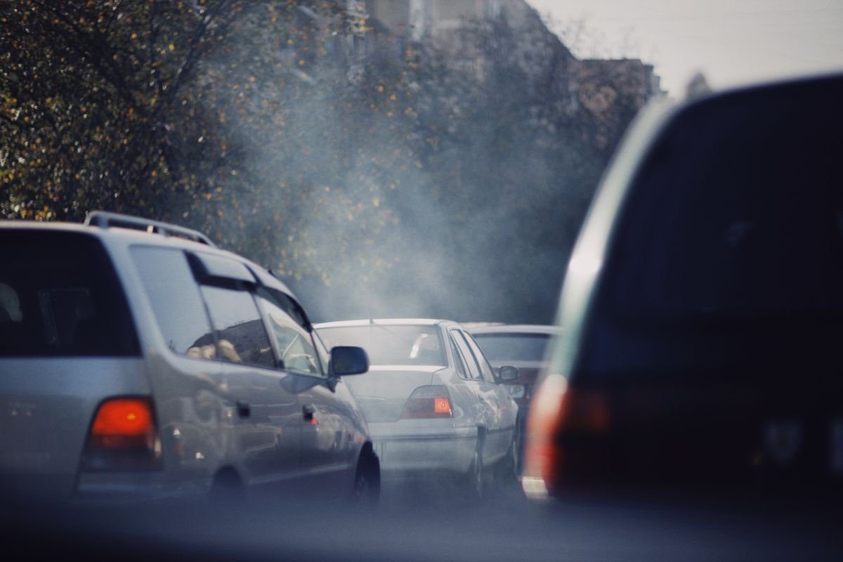 City traffic jam with vehicles emitting exhaust smoke