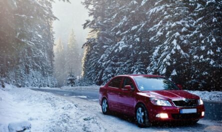 Car driving along a snowy road in winter
