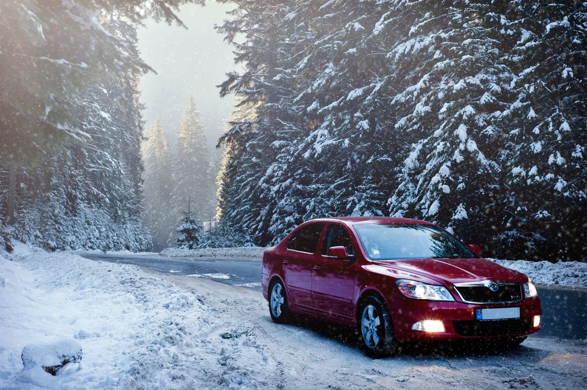 Car driving along a snowy road in winter