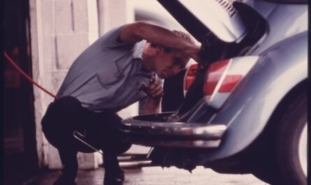 Mechanic inspecting a vehicle at a service station